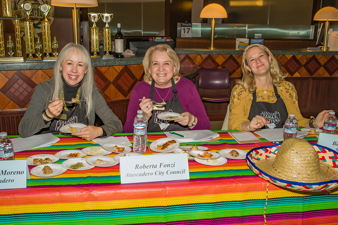 Image of 2020 Tamale Festival Tamale Judges Mayor Heather Moreno, Council Member Fonzi and Beth Giuffre of New Times poised to sample a bite of tamale.